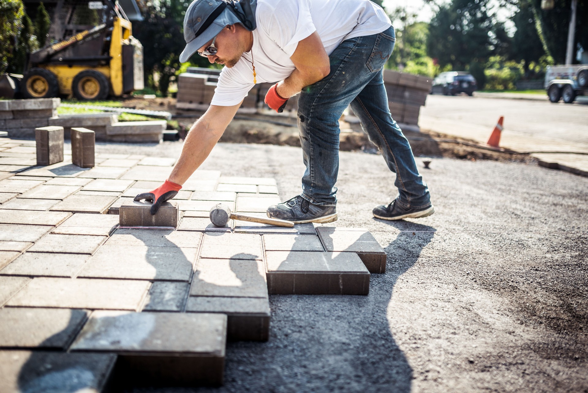 Young man installing paving stones
